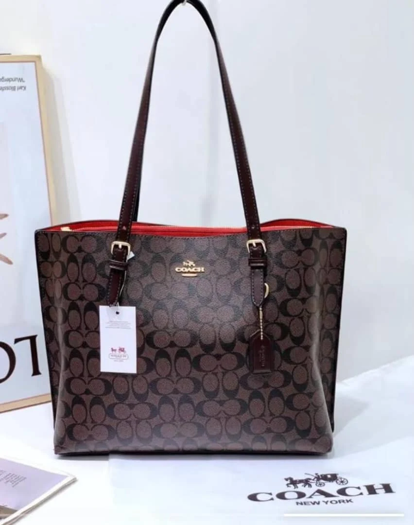 Coach patterned tote with dark handles and red trim