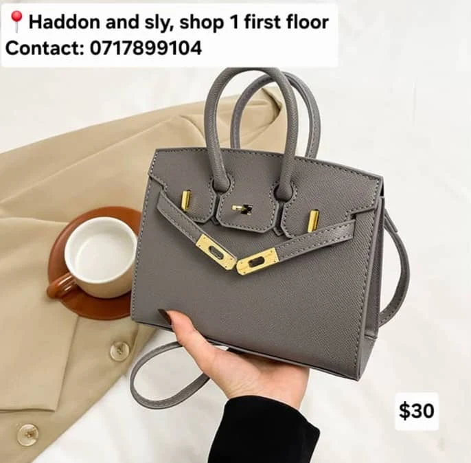 Owner-supplied photo of a grey handbag with gold details
